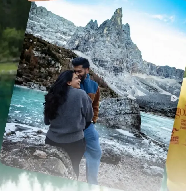 Couple beside an alpine lake below jagged Dolomite peaks